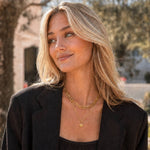 woman wearing a gold lock pendant necklace