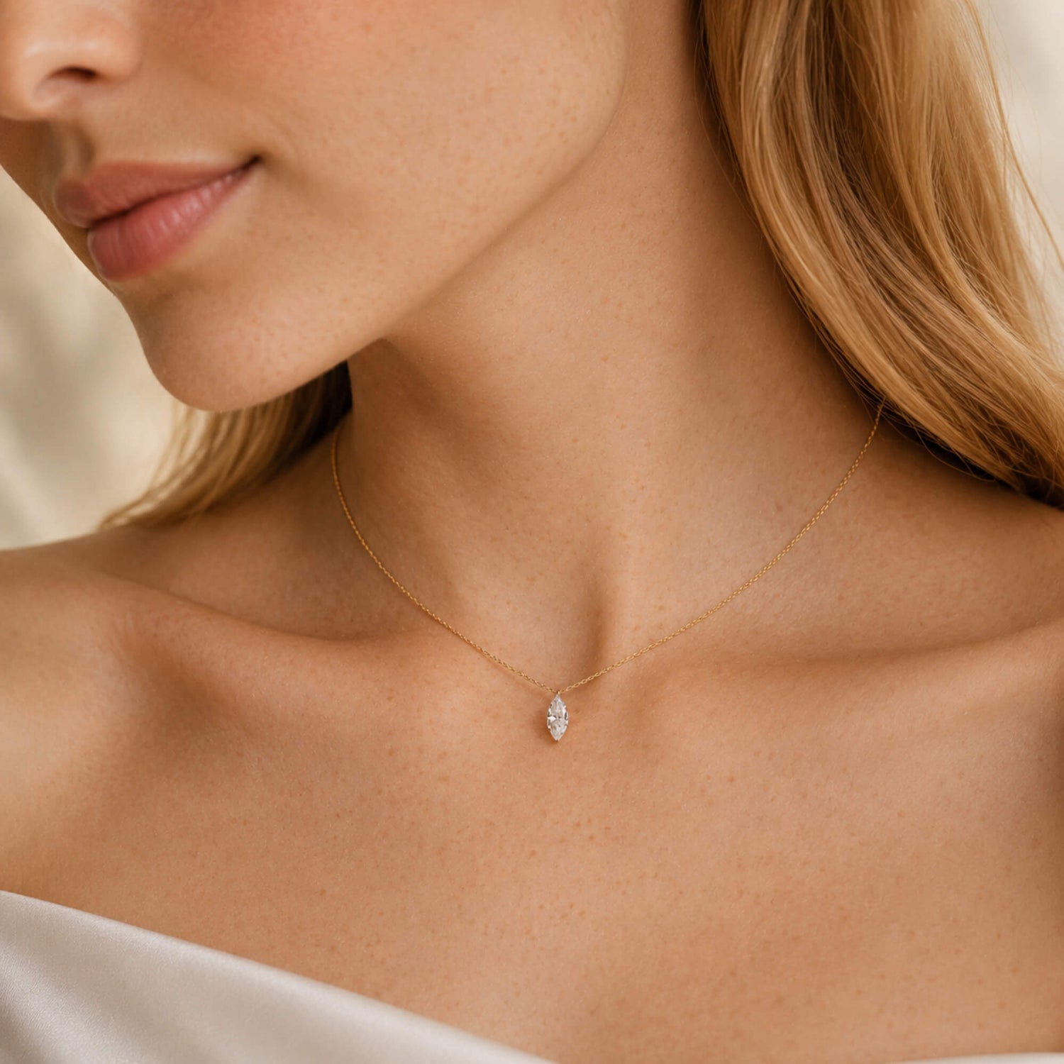 woman wearing a gold marquise diamond necklace
