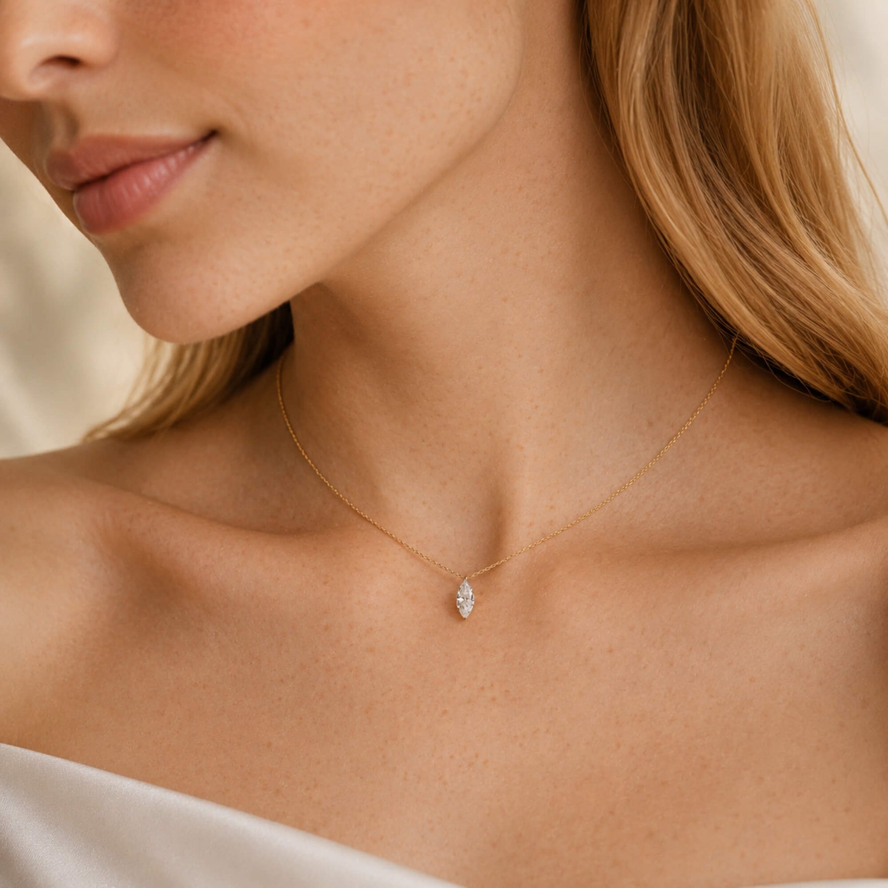 woman wearing a gold marquise diamond necklace