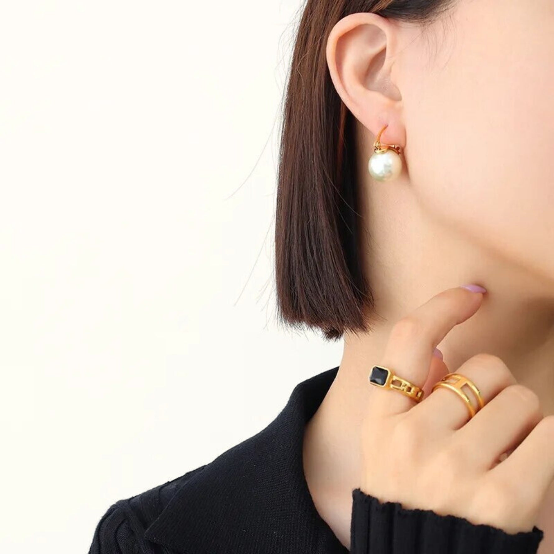woman wearing pearl stud earrings