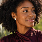 woman wearing pearl flower stud earrings