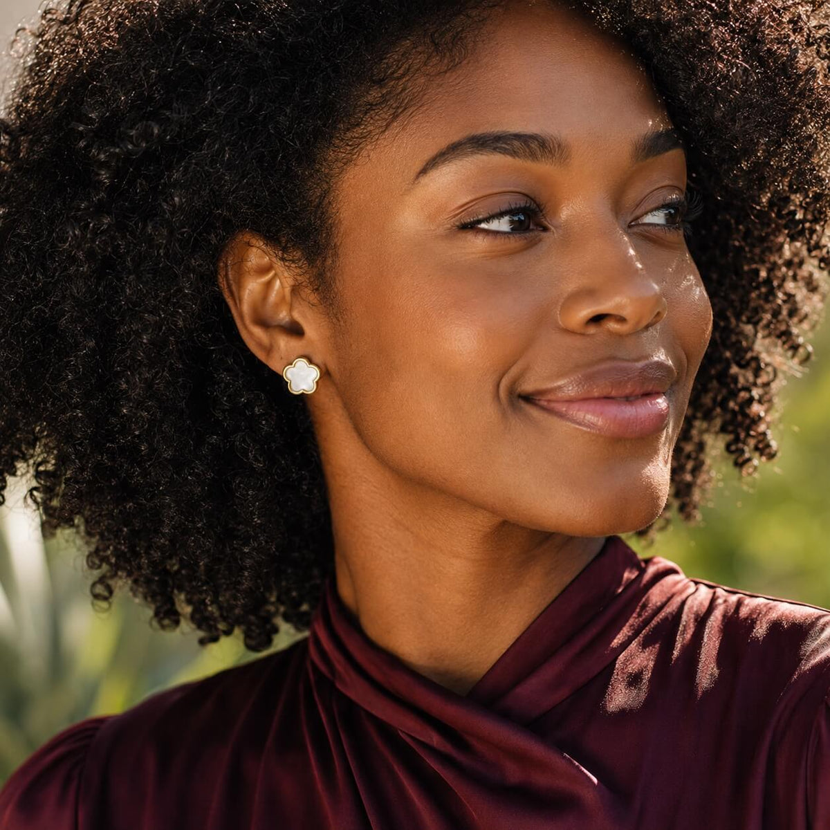 woman wearing pearl flower stud earrings