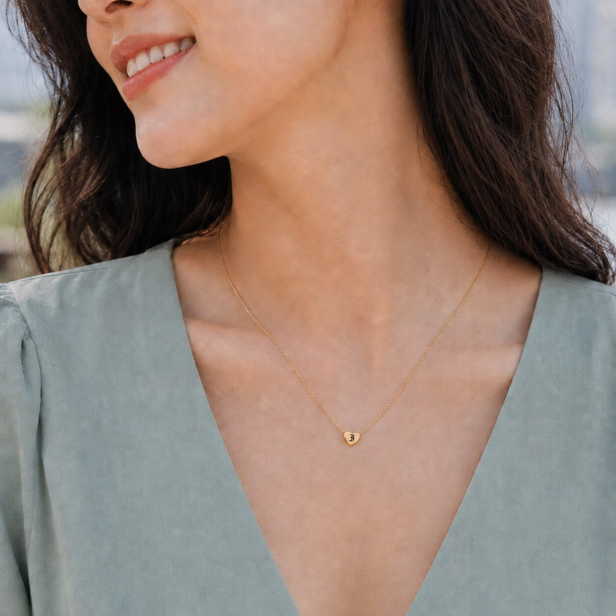 woman wearing a heart pendant necklace