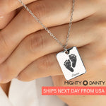 woman holding fingerprint pendant necklace