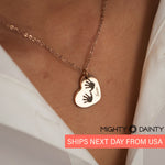 woman wearing baby footprint necklace
